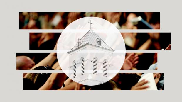 People raise their hands to pray in a church.