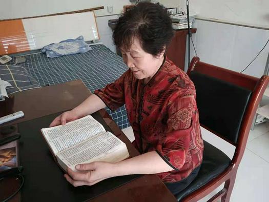 Song Qinghua read the Bible at her home in early September 2021.