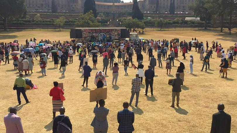 Families bathe and wash clothes in the Taia River, near Taiama, Sierra Leone. Churches are lobbying the government to limit water pollution caused by diamond and gold mining.