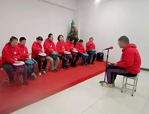Children with Down syndrome presented a program named "Two Tigers" with African drums at Reed's Home in Zhenjiang, Jiangsu, on January 22, 2022.