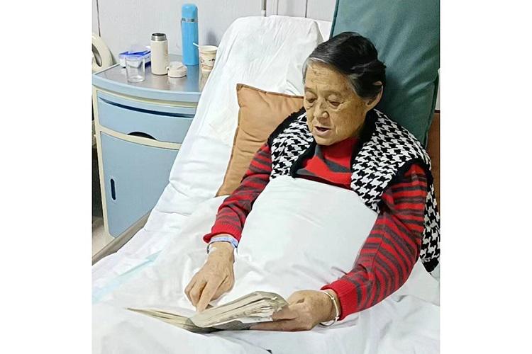 A picture shows the author's mother singing a hymn before a surgery in early March, 2022.