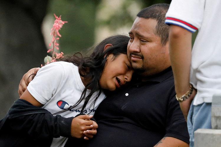 People react outside the Willie de Leon Civic Center in Uvalde, Texas, where students had been transported from Robb Elementary School after a shooting that left 19 children and two teachers dead.