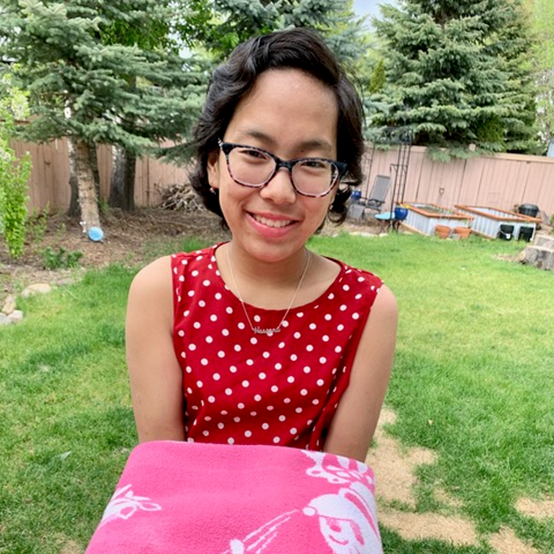 Hosanna is now 16 years old, healthy with curly hair due to the chemotherapy she had during her bone marrow transplant. She is standing strong, holding the blanket that was around her the day she met her forever family.