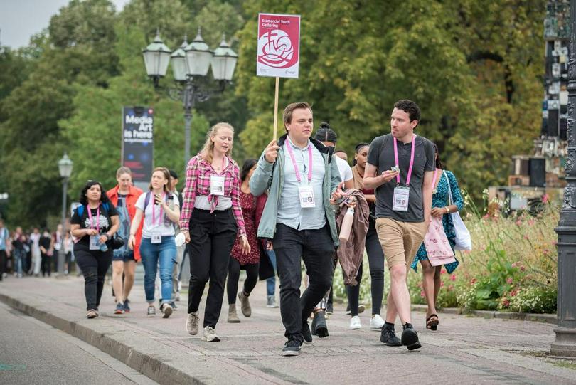 Participants in an Ecumenical Youth Gathering that brings together hundreds of youth from all over the world in the lead-up to the World Council of Churches 11th Assembly in Karlsruhe, Germany walk through town towards the assembly venue in Karlsruhe, Germany, on 27 August 2022. 