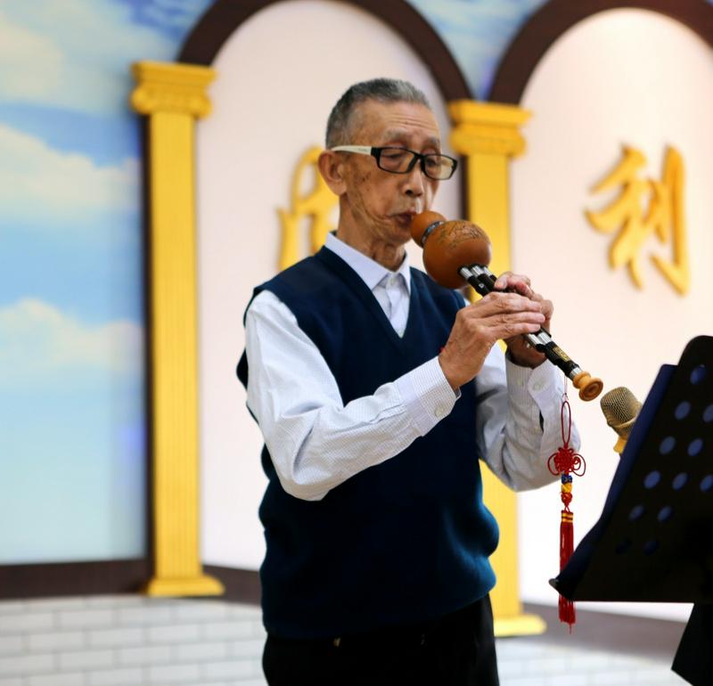 Bai Dianfu played the hulusi in a praise and worship meeting on an unknown day.