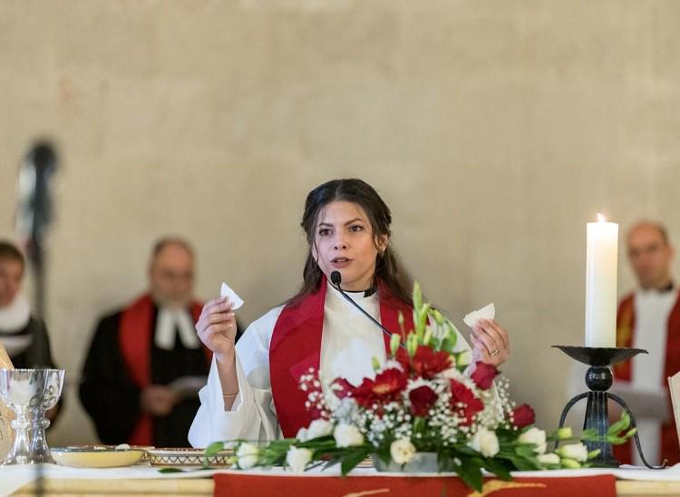 Rev. Sally Azar, ordained minutes earlier as pastor in the Evangelical Lutheran Church in Jordan and the Holy Land, presides over Holy Communion at the conclusion of her ordination service at the Lutheran Church of the Redeemer in Jerusalem, Palestine, on 22 January 2023.