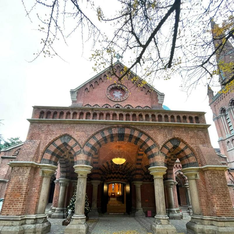 A picture of the front view of the Holy Trinity Cathedral in Shanghai with the yellow leaves all over the ground